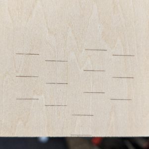 Engraved wood showing 4 sets of test lines indicating skipped steps.